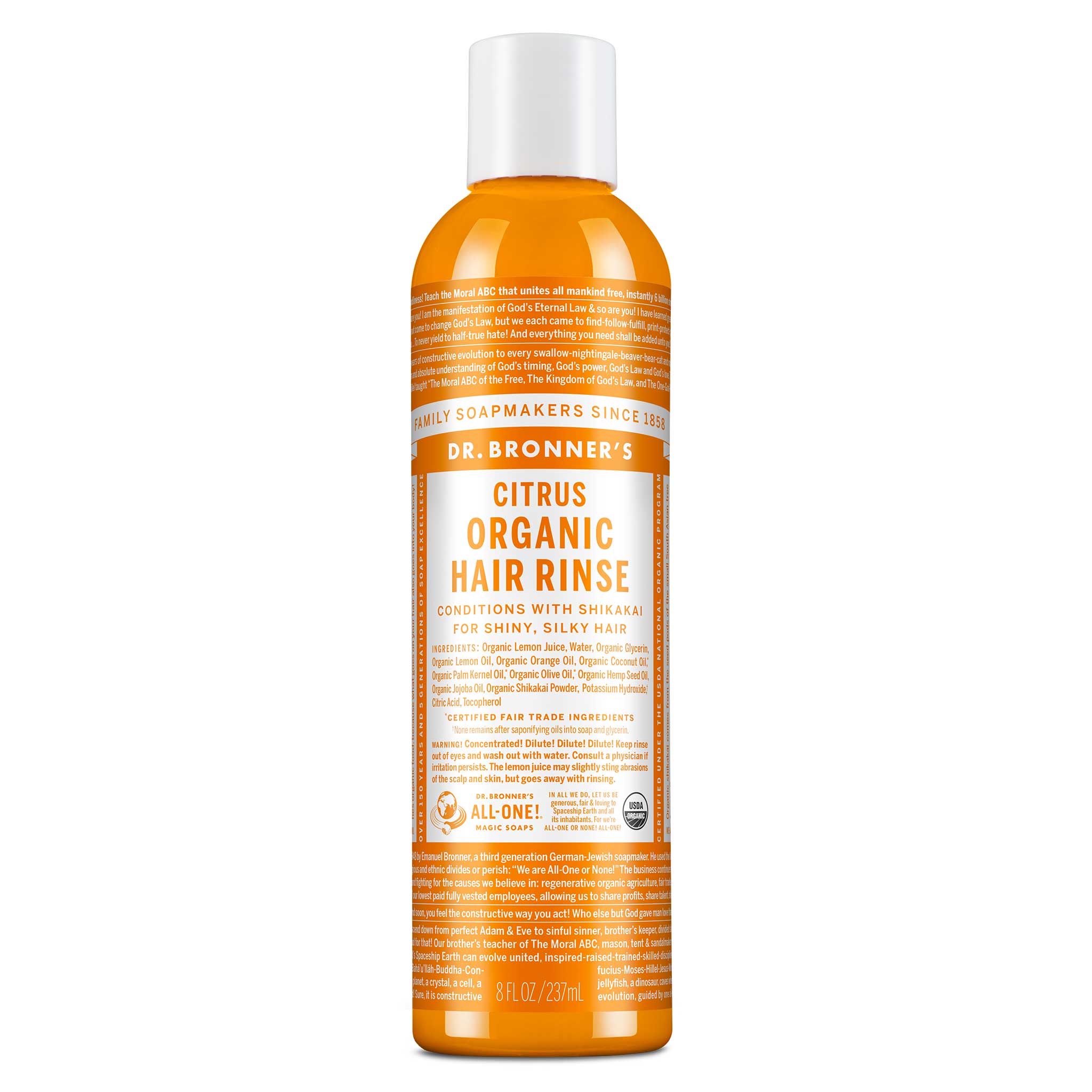 A bottle of Dr. Bronners Citrus Organic Hair Rinse stands upright. The orange bottle features detailed text about its conditioning benefits with shikakai for shiny, silky hair. Label promotes fair trade and organic certification [8 oz]