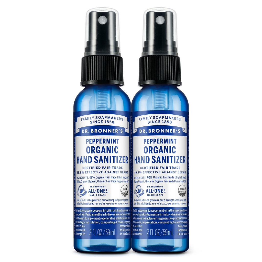 Two blue 2 fl oz bottles of Dr. Bronners Peppermint Organic Hand Sanitizer with spray tops, labeled as certified fair trade. Text reads FAMILY SOAPMAKERS SINCE 1858, PEPPERMINT ORGANIC HAND SANITIZER, CERTIFIED FAIR TRADE, and ALL ONE Ideal for eco friendly hygiene