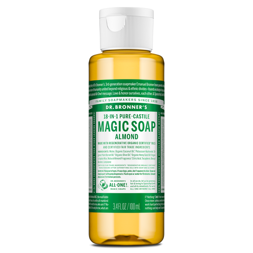 A small bottle labeled Dr. Bronners 18 in 1 Pure Castile Magic Soap Almond contains liquid castile soap in a clear container with a white flip top cap, featuring green, detailed text [3.4 oz]